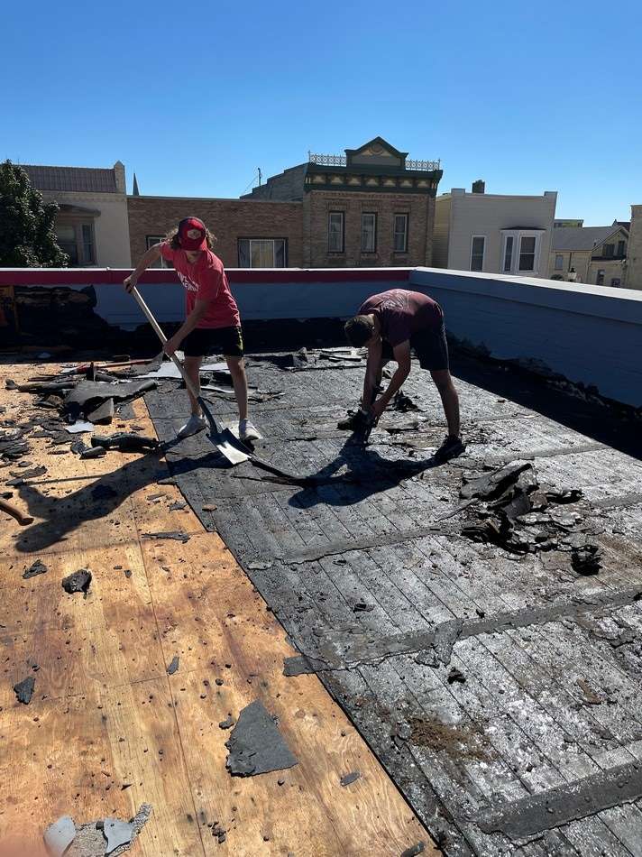 Professional surface preparation for fabric reinforced membrane restoration ensuring proper adhesion and longevity